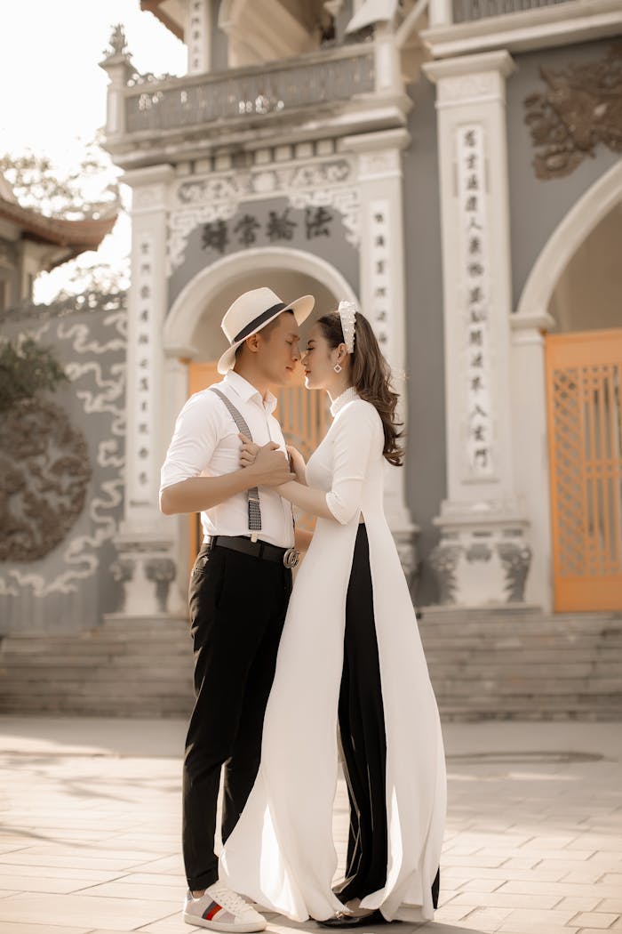 The Art of Drawing Readers In: Your attractive post title goes here Elegant couple in traditional attire embracing during a prewedding shoot in Vietnam.